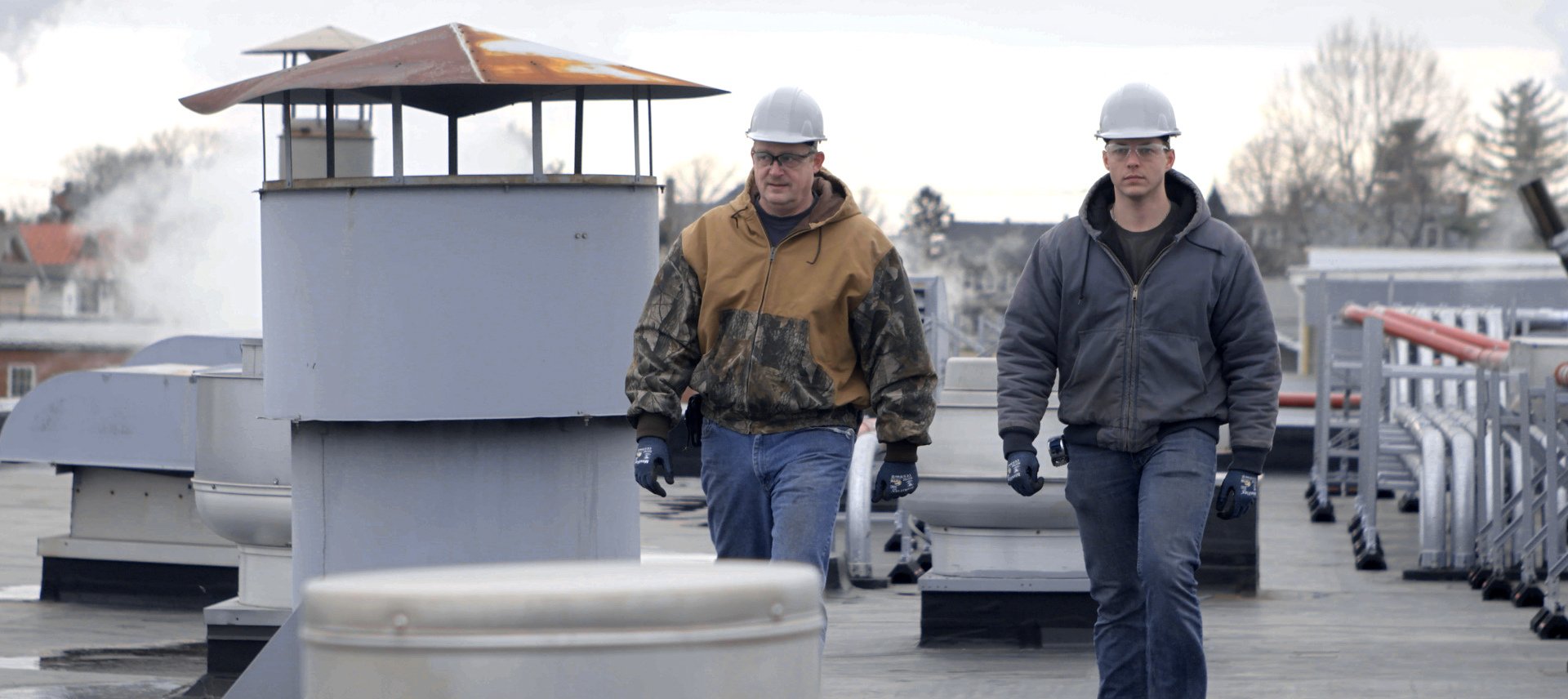 Two protected workers walking on rooftop